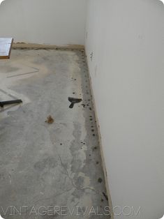 an unfinished room that is being remodeled with white walls and concrete flooring on the ground