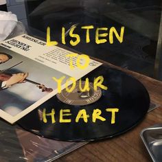 a record with the words listen to your heart written on it next to an album