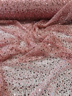 pink sequin fabric with black dots on it