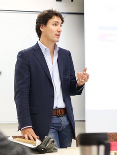 a man standing in front of a whiteboard giving a presentation