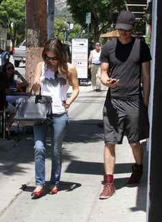 a man and woman walking down the street