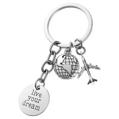 a keychain with an airplane and a globe on it that says live your dream