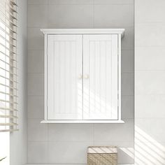 a bathroom with a sink, mirror and cabinet in it's corner next to the window