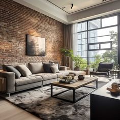 a living room filled with furniture and a brick wall behind the couch is a large window