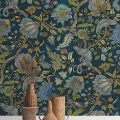 two vases with flowers and birds in front of a blue wallpapered background