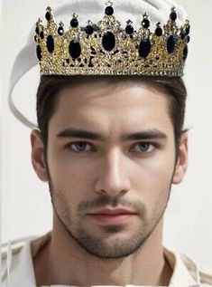 a man with a crown on his head looking at the camera while wearing a white shirt