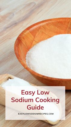 a wooden bowl filled with white flour next to a wooden spoon on top of a wooden table