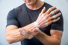 a man is holding out his hands to show the muscles