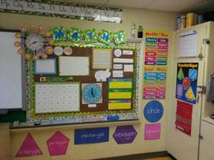 a bulletin board and refrigerator in a classroom