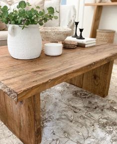 a wooden table topped with a potted plant