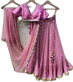 Pink Lehenga With Unstitched Blouse For Transitional Season, Fitted Art Silk Dresses For Traditional Ceremonies, Fitted Dresses In Art Silk For Traditional Ceremonies, Traditional Unstitched Blouse With Long Skirt Set, Fitted Art Silk Sharara For Traditional Ceremonies, Pink Long Skirt Set For Diwali, Long Skirt Set With Unstitched Blouse For Wedding, Fitted Skirt Set With Dori Work For Diwali, Pink Sets With Traditional Drape For Transitional Season