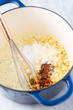 a blue pot filled with corn and spices