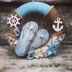 a blue wreath with an anchor, heart and starfish on it sitting in a pile of fur