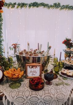 a table topped with lots of food and desserts