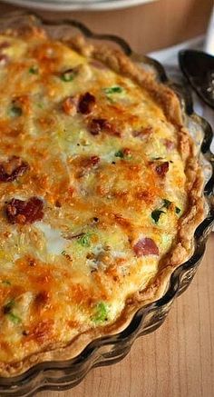 a quiche is sitting on a wooden table