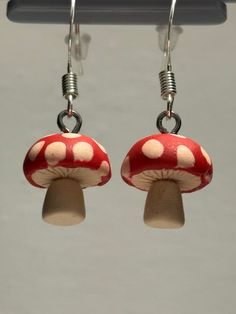 Elevate your style with these handmade clay mushroom earrings! Delightfully whimsical and lightweight, they add a touch of charm to any outfit. Perfect for nature lovers and those who appreciate unique accessories. Stand out with these playful earrings! Whimsical Mushroom-shaped Earrings For Gifts, Whimsical Dangle Earrings With Mushroom Design, Cute Mushroom Design Dangle Earrings, Cute Dangle Earrings With Mushroom Design, Unique Adjustable Mushroom Earrings, Fun Mushroom Design Jewelry For Gifts, Handmade Cute Mushroom Earrings, Cute Handmade Mushroom Earrings, Cute Mushroom Design Dangle Jewelry