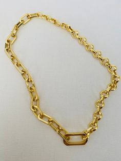 This versatile necklace offers three different looks in one stunning piece of jewelry. Crafted with a combination of two gold chains, including a gold paper clip chain and round rolo chain, it is finished with a connector clasps. The necklace measures approximately 17 inches in length and can be rotated to achieve three distinct styles. In the first look, you can showcase the bold statement necklace by wearing it with the gold paper clip chain prominently displayed. The unique and contemporary d Asymmetrical Necklace, Bold Statement Necklaces, Gold Statement Necklace, Gold Paper, Rolo Chain, Paper Clip, Gold Chains, Statement Necklace, Two By Two