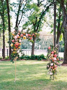 an outdoor wedding ceremony setup with floral arch