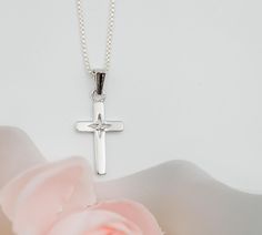 From our "Timeless Collection" this cross pendant necklace is a beautiful keepsake piece featuring a tiny sparkling diamond that's just perfect for a First Communion, Confirmation, Christening, or Baptism gift.   🌸This piece is rhodium-plated to prevent tarnish for everlasting quality 🌸High-end Italian chain with durable lobster clasp is available in two lengths: 14" or 16-18" adjustable. (see sizing chart in photos) 🌸This necklace comes in our Timeless Collection gift box!  🌸PERSONALIZE IT! Cross Jewelry For Confirmation And Mother's Day, Mother's Day Cross Pendant Necklace, Sterling Silver Cross Necklace For First Communion, Sterling Silver Cross Pendant Necklace For First Communion, Silver Cross Pendant Jewelry For Baptism, Silver Cross Jewelry For Confirmation, Silver Cross Necklace For Confirmation, Silver Cross Necklace For Baptism, White Gold Cross Pendant For First Communion