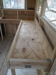 the inside of a tiny house with wood flooring and window sill in it