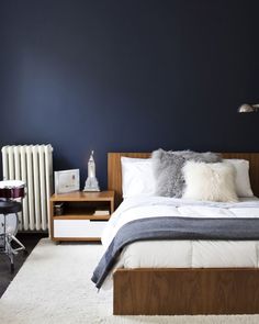 a bedroom with blue walls and white carpet