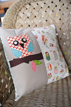 an owl pillow sitting on top of a wicker chair