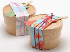 two wooden boxes with colorful wrapping paper tied to them