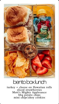 a bento box lunch with turkey, cheese on hawaiian rolls, fruit and chips