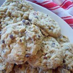 a white plate topped with cookies on top of a red and white striped table cloth