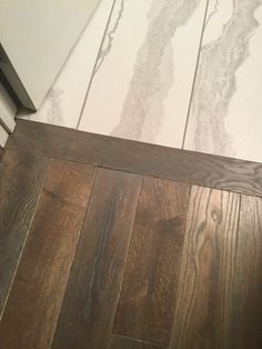 a white refrigerator freezer sitting on top of a wooden floor