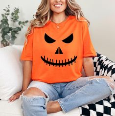 Halloween Boo Shirt, Fall Shirt, Halloween Pumpkin Shirt, Jack-O-Lantern Shirt, Love Boo Shirt, Cool Halloween Shirt, Spooky Tee, Pumpkin Face Shirt HOW TO ORDER: 1. Please, Check and Review all Photos and Size Charts (The V-necks and Tank Tops are Women's Size, and the other styles are Unisex) 2. Choose Your T-Shirt Color/Size (You can see youth and toddler options in the same drop-down menu) 3. Choose Your Quantity as much as you want. 4. Click "Add To Cart". For multiple items go back to the listing and repeat the steps. *T-SHIRTS QUALITY: The T-Shirts are relax fitted. Black, Navy and White t-shirts are 100% cotton. Other colors are cotton/poly blend. Sweatshirts are 50/50 cotton/polyester. * PROCESSING & SHIPPING: Processing is 1-2 days. First Class Shipping is 2-5 business days (afte Casual Orange Tops For Halloween, Spooky Short Sleeve Orange Shirt, Orange Halloween Tops With Character Print, Fall Orange Tops With Character Print, Orange Tops With Character Print For Fall, Orange Character Print Tops For Fall, Orange Crew Neck Top For Halloween, Orange Graphic Print Shirt For Halloween, Orange Crew Neck Shirt For Halloween