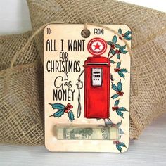 an old fashioned red gas pump with money in front of it and the words, all i want for christmas is money