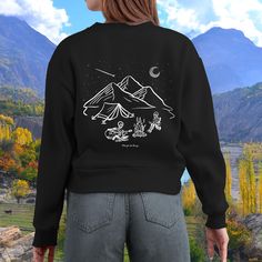 🔥 Cozy Campfire Night Crewneck Embrace the perfect blend of spooky and serene with our Skeletons Camping Sweatshirt. This crewneck features a captivating line drawing of two skeletons enjoying a peaceful night around the campfire. With stars shining above the mountains and a shooting star streaking across the sky, this design captures the magic of a night under the stars with a spooky twist. 🌲 Finest Features: Cozy and Durable:  Made with 100% cotton, this ultra cotton long sleeve tee offers a Winter Camping Graphic Print Tops, Relaxed Fit Long Sleeve Tops For Camping, Relaxed Fit Graphic Sweatshirt For Camping, Crew Neck Winter Tops For Camping, Skeletons Camping, Campfire Night, Camping Sweatshirt, Cozy Campfire, Peaceful Night