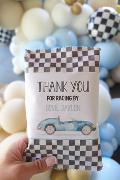 a person holding up a card that says thank you for racing by with a car on it