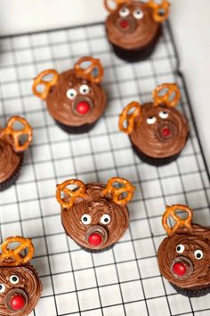 cupcakes with chocolate frosting and decorated like reindeer heads on a cooling rack