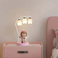 Introducing the Econiko Cute Rabbit Princess Bedside Lamp, a delightful addition to any child's room. This charming table lamp is thoughtfully designed to create a warm and inviting atmosphere while also being gentle on the eyes. Perfect for bedtime stories, playtime, or simply adding a touch of whimsy to the decor. Crafted with care and attention to detail, this lamp features a frosted glass shade that emits a soft and soothing light. The modern style and iron finish make it a perfect fit for any bedroom decor. The LED bulbs provide energy-efficient lighting that is sure to last for years to come. With a wattage range of 6-10W, this lamp offers just the right amount of brightness for reading or relaxing. The knob switch allows for easy on/off control, while the G4 base type ensures compat Childrens Desk, Desk Lamps Bedroom, Flower Bedroom, Bedroom Bedside Lamp, Table Lamps For Bedroom, Desk Light, Bedside Lamp, Led Night Light, Floor Lamp Lighting