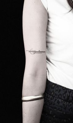 a woman's arm with a tattoo on it and an arrow in the middle