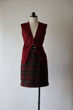 "Vintage 1970s - 1980s pointelle sweater vest in the dreamiest shade of dark red wine color (I'm craving some Cabernet) with deep V neckline, 5 small buttons front closure, wide ribbed waist band and slim silhouette. Super lightweight mohair blend yarn, unlined, see-through. Made in Hong Kong.  This listing is for the vest only. M E A S U R E M E N T S  (taken flat, unstretched) size on tag: vintage L / please check measurements below for a perfect fit fits like: approx. medium / large bust (arm Fitted Cable Knit Vest For Fall, Fitted Red Knit Sweater Vest, Red Fitted Knit Sweater Vest, Fitted Wool Sweater Vest For Layering, Fitted Vintage Sweater Vest With V-neck, Vintage Fitted V-neck Sweater Vest, Fitted Vintage V-neck Sweater Vest, Fitted Wool Sweater Vest In Vintage Style, Fitted Wool Sweater Vest For Fall