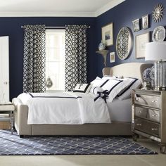 a bedroom with blue walls and white furniture