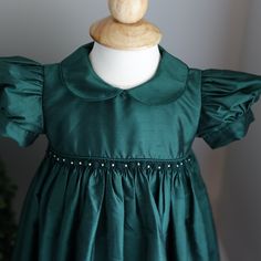 This Strasburg Emerald Green Dress Size 24 Months Is Most Gorgeous!!! Made Of 100% Luxurious Dupioni Silk. Smocking At Waist With Hand Embroidery Emerald Rosettes With White Pearls In Between. Sweet Peter Pan Collar That Is Edged In Matching Piping. Waist Is Trimmed In Matching Piping Also. Short Puff Sleeves Are Finished With A 1 Inch Matching Silk Band.Upper Button Back With Matching Silk Fabric Buttons (High-End Detail). A Wide Tie Back Sash Is The Finishing Touch With This Exquisite Strasbur Emerald Green Dress, Emerald Green Dresses, Cotton Slip, Fabric Buttons, Dupioni Silk, Dress Silk, Pan Collar, Peter Pan Collar, Kids' Dresses