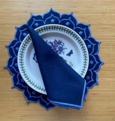 a blue napkin sits on top of a white plate