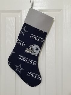 a stocking hanging on the front door with cowboys logo and star designs in it