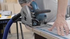 a person using a circular saw to cut wood with a cordless jig attachment