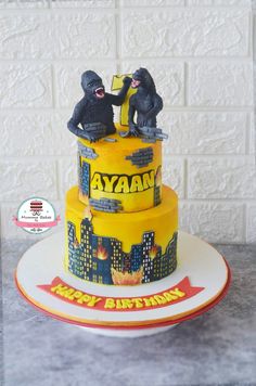 a birthday cake with two gorillas on top and happy birthday written on the side