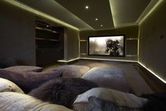 a large room with couches and a projector screen in the middle of it