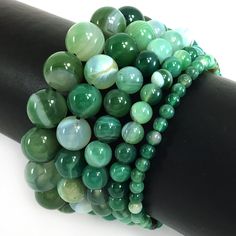 ✦Gemstone: Stripe Agate ✦Color: Green  ✦Shape: Smooth Round Beads ✦Size: 4mm, 6mm, 8mm, 10mm, 12mm ✦Average Strand Weight: < 4oz ✦QTY: 1 pc / package ♕Beautiful & High Quality Bracelet♕  Our bracelet length 7.5", fit with a 6.75" wrist, it is our standard size. We offer to resize bracelet 5"-8" to fit your wrist! If you like the different bracelet lengths, please let us know your wrist size. We are happy to take care of it for you. You can see our Personalization Option. Thank you! MEASURE YOUR WRIST:    - Measure around at the wrist bone in tape or even a strip of paper.   - Choose a place where you would normally wear a bracelet.  Make it as loose or snug.   - To use the strip of paper, mark where the end of the bracelet needs to be and then measure the paper with a ruler.   - Increase t St Patrick's Day Gifts, Saint Patrick's Day, Agate Bracelet, Green Agate, Saint Patrick, Mens Jewelry Bracelet, Bracelet Sizes, Round Beads, Beaded Bracelet