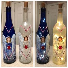 three bottles with angel images on them and some lights in the bottom one is empty