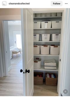 an open closet with baskets and bins on the bottom shelf in front of it