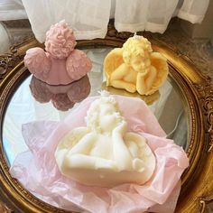 three soaps sitting on top of a mirror