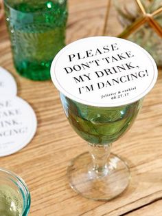 a wine glass with a sticker that says please don't take my drink i'm dancing